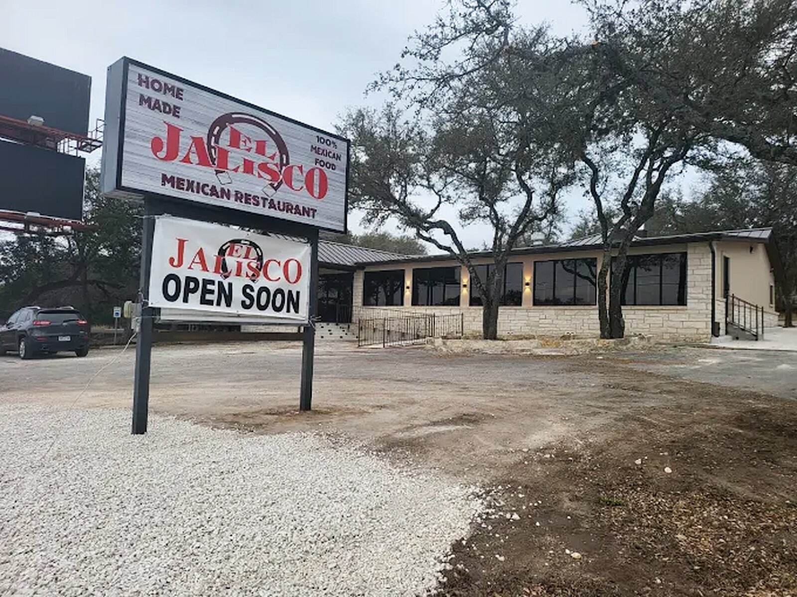A second El Jalisco building with an Open Soon sign at the road
