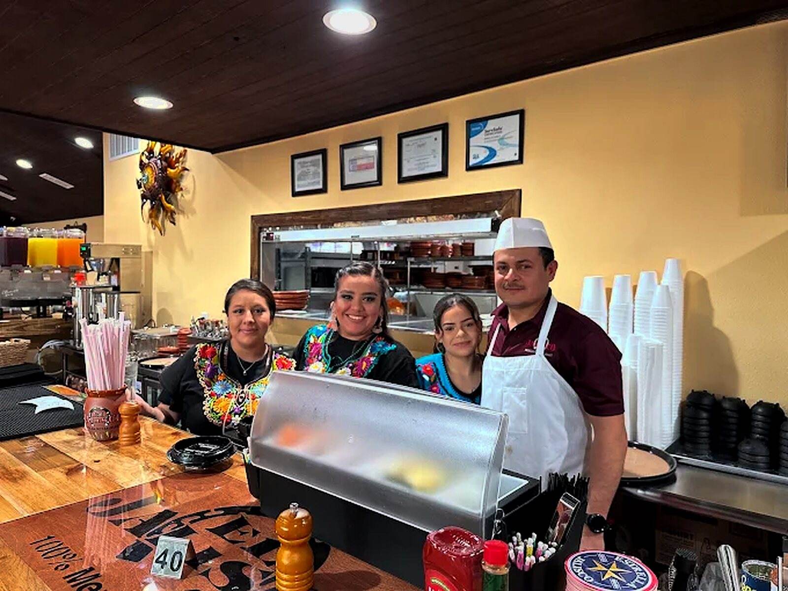 Four members of the El Jalisco #3 team behind the front counter